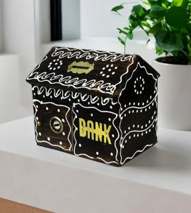 Artistic handcrafted dark-brown wooden money bank or gullak with a coin slot for childrens